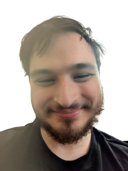 A young white boy with a narrow-eyed smile, wearing a black shirt with black hair, beard, and moustache